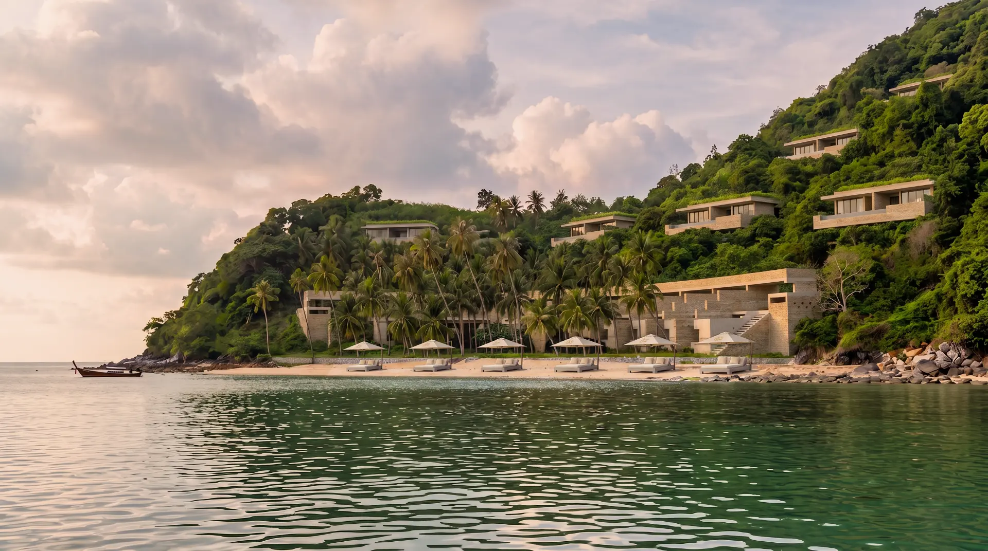 Illustrative beachfront resort of stone and timber pavilions set into the forested headland